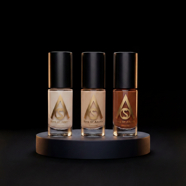 Three bottles of Sons of Adonis concealer  in light beige, medium tan, and medium brown shades, displayed on a dark round pedestal against a black background.